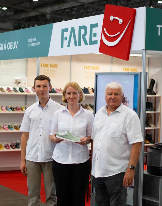 Three members of the Šůstek family at the FARE exhibition stand with children’s shoes